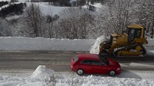 Bulldozer And Trucks With Snow Plough Cleaning Street From Ice And Snow In Winter. A Column Of Five Snow-remover Trucks On The Road On Mountain During A Snowfall. Cleaning Road From Snow Storm.Weather