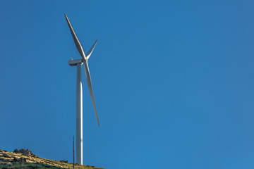 Wall Mural - View of a wind turbine on top of mountains