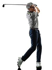 Wall Mural - one caucasian senior man golfer golfing  in studio shadow silhouette isolated on white background