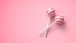 Two sweet striped pink and white lollipops on stick on bright pink background
