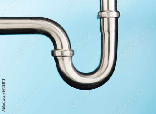 Photographie Stainless steel sink pipe on isolated on light blue background