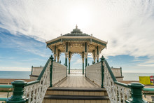 Brighton Pier Beach With Victorian Bandstand Octagonal Pavilion Chinese And Indian Style In The Background At Brighton Sussex, UK.
