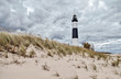 Lighthouse Beach Background. The Big Sable Lighthouse on the coast of Lake Michigan surrounded by dune grass and sand dunes at Ludington Stat Park in Michigan.