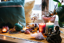 Feng Shui Altar At Home In Living Room Or Bed Room. Attracting Wealth And Prosperity Concept. Crystal Clusters, Wire Tree With Gemstones, Golden Buddah Figure On Table And Window Sill. Vibrant Colors.