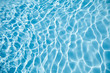 © mikeosphoto - water surface in swimming pool with sun reflection, ripple, abstract background