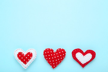 Fabric hearts on blue background