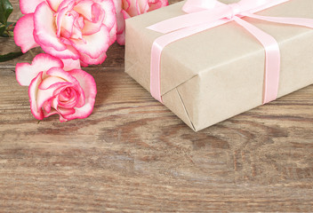 Wall Mural - Present or gift box in a craft paper with gold ribbon bow