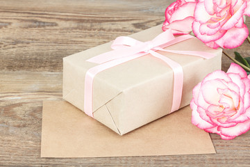 Wall Mural - Present or gift box in a craft paper with gold ribbon bow