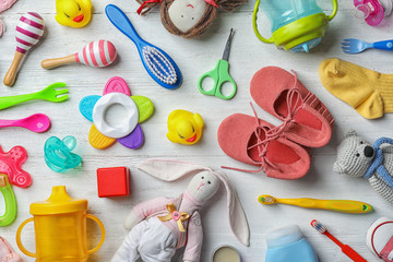 Wall Mural - flat lay composition with baby accessories and toys on light wooden background