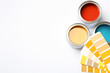 Paint cans and color palette on white background, top view. Space for text