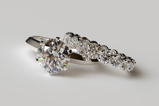 Solitaire diamond engagement ring, eternity ring on white background