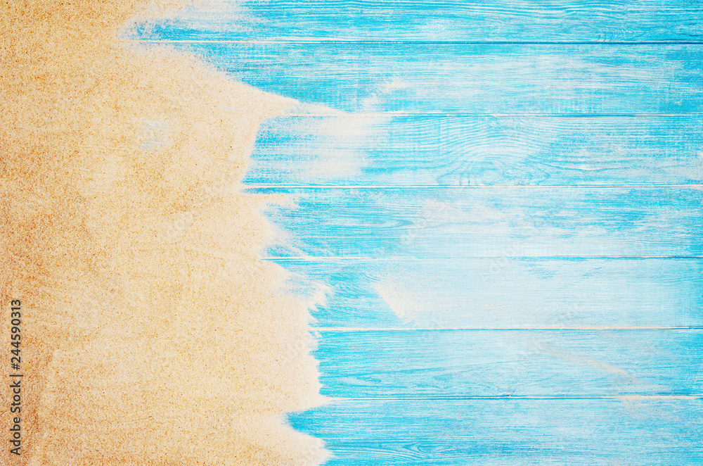 Top view of sandy beach and marine blue planks pier. Background with copy space and visible sand and wood texture. - obrazy, fototapety, plakaty 