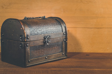 Old treasure box on wooden background antique