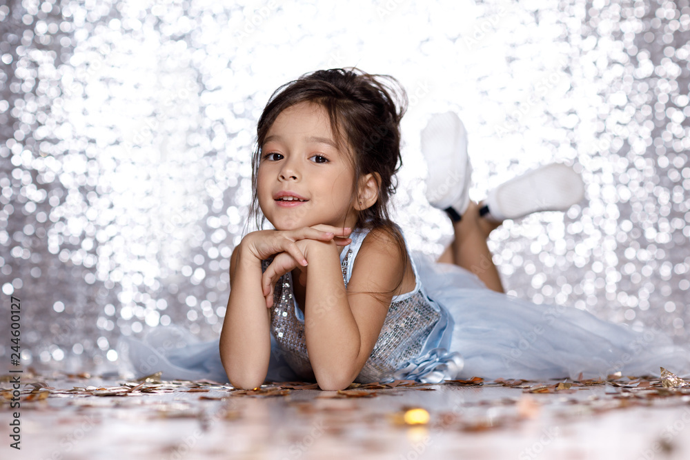 little girl in blue dress sitting on the floor with confetti Stock ...