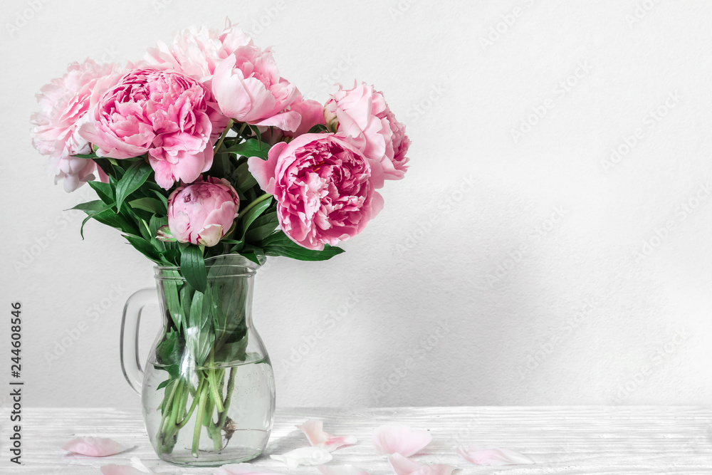 beautiful bouquet of pink peony flowers in vase. womans day or wedding background with copy space - obrazy, fototapety, plakaty 