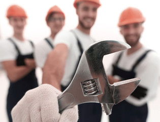 closeup. the wrench in the hands of the builders