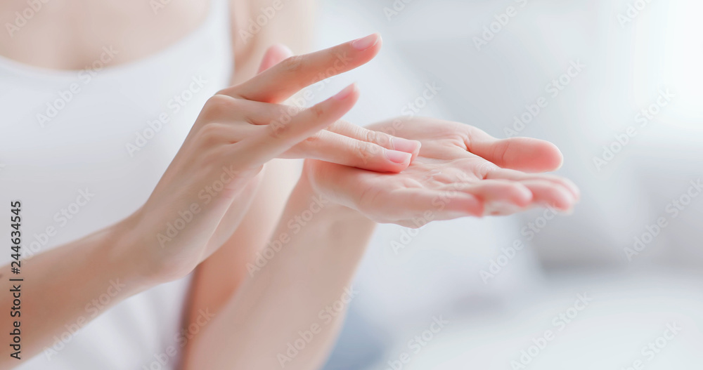 woman apply moisturizer in hand - obrazy, fototapety, plakaty 