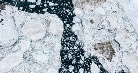 Wall Mural - Icebergs drone aerial image top view - Climate Change and Global Warming. Icebergs from melting glacier in icefjord in Ilulissat, Greenland. Arctic nature ice landscape in Unesco World Heritage Site.