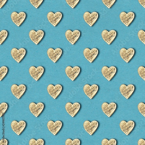 Golden hearts seamless pattern. Gold glitter on blue old paper background