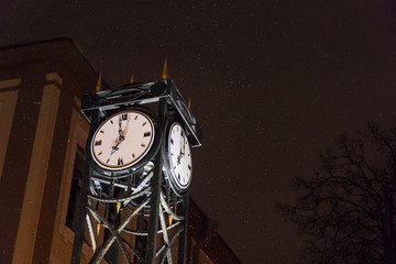 The vintage city clock in the street at night