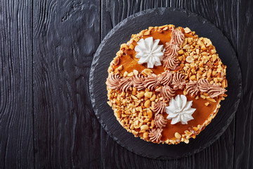 Wall Mural - peanut cake topped with cream, top view