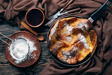 Wall Mural - dutch baby pancake sprinkled with powdered sugar