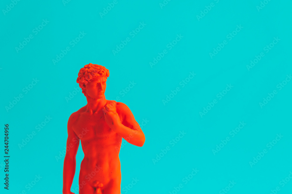 Creative concept of red neon David is a masterpiece of Renaissance sculpture created  by Michelangelo. Vaporwave style. Turquoise background. - obrazy, fototapety, plakaty 