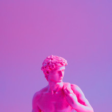 Creative Concept Of Purple Neon David Is A Masterpiece Of Renaissance Sculpture Created  By Michelangelo. Vaporwave Style  .