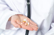 © gallofilm - Female doctor hand holding pills