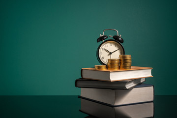 Wall Mural - Coins and stalking books with low light