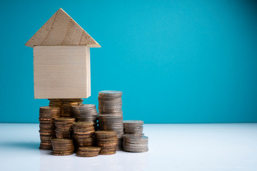 Coins stacking and wooden cube with financial concept.