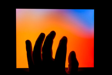 Hand using touch screen tablet business computer night