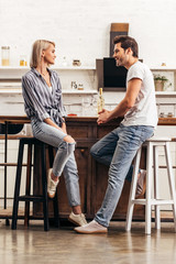 attractive girlfriend and handsome boyfriend sitting on chairs