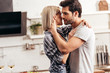 © LIGHTFIELD STUDIOS - handsome boyfriend and attractive girlfriend hugging in kitchen