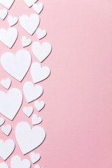 Wall Mural - White hearts on a pastel pink background. Valentine's day, Mother's day background