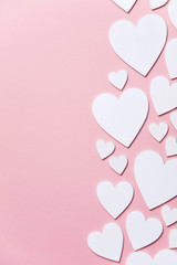 Wall Mural - White hearts on a pastel pink background. Valentine's day, Mother's day background