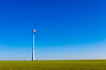 Ecology concept, wind generator, windmills, wind turbine for electricity, alternative with blue sky and sunshine. 