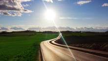 Curved Road, Uphill Path, Clear Sky, Bright Day, Vivid Landscape, Rich Colors, Clouds, Horizon, Lens Flares