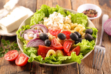 Wall Mural - mixed salad with pasta, tomato, olive and cheese