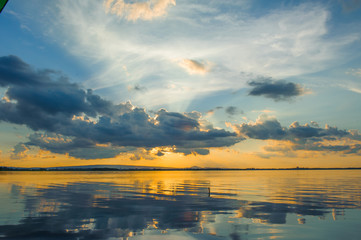 Wall Mural - sunset sky with clouds above lake, tourist attraction nong han lake at sakon nakhon province in thai