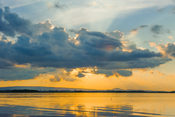 Wall Mural - sunset sky with clouds above lake, tourist attraction nong han lake at sakon nakhon province in thai
