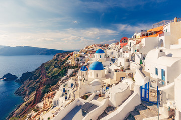 Fototapete - Architecture of Oia village, Santorini island in Greece, on a sunny day with dramatic sky. Scenic travel background.