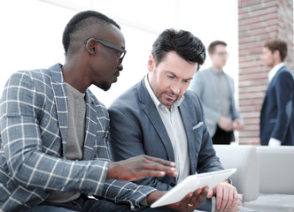 Wall Mural - two business partners use a digital tablet.