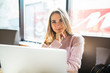 © dianagrytsku - Beautiful young woman using laptop at cafe look at camera in cafe