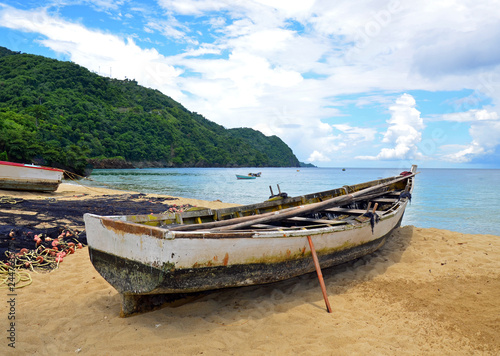A Rustic Native Tobago Wooden Fishing Boat Propped Up On Sandy Tobago Wooden Fishing Boat Propped Up