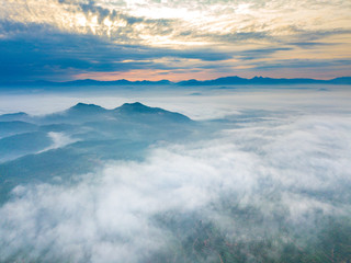 Wall Mural - Aerial view of mountain and morning mist during sunrise.