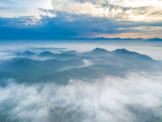 Wall Mural - Aerial view of mountain and morning mist during sunrise.