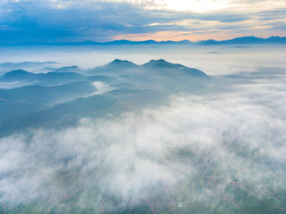 Wall Mural - Aerial view of mountain and morning mist during sunrise.