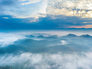 Wall Mural - Aerial view of mountain and morning mist during sunrise.