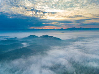 Wall Mural - Aerial view of mountain and morning mist during sunrise.